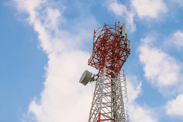 Wireless Communication Antenna Transmitter. Telecommunication tower with antennas on blue sky background.