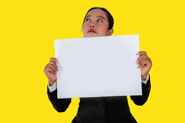 Communicate negative emotions, Business person holding a blank white paper in hand isolated on yellow background.