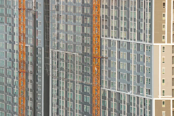 Construction project of a large building with a yellow crane