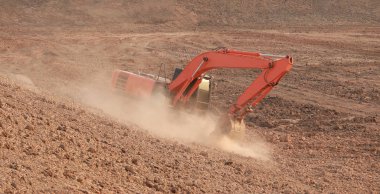 Turuncu ekskavatör Yapım aşamasında Büyük rezervuar, Toz toprak kazma tarafından.