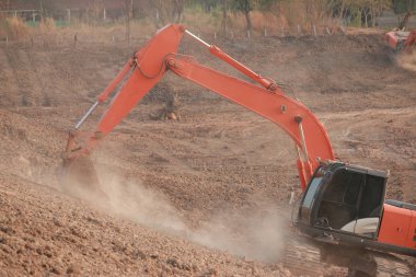 Turuncu ekskavatör Yapım aşamasında Büyük rezervuar, Toz toprak kazma tarafından.