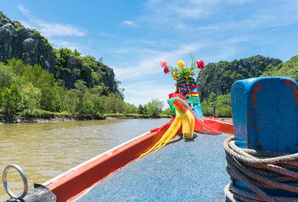 Khao Dang canal boat trip at Prachuap Khiri Khan Thailand. Boat or fishing boat and rock or stone mountain or hill with blue sky and cloud and green tree and water. Landscape or scenery summer concept for boat trip