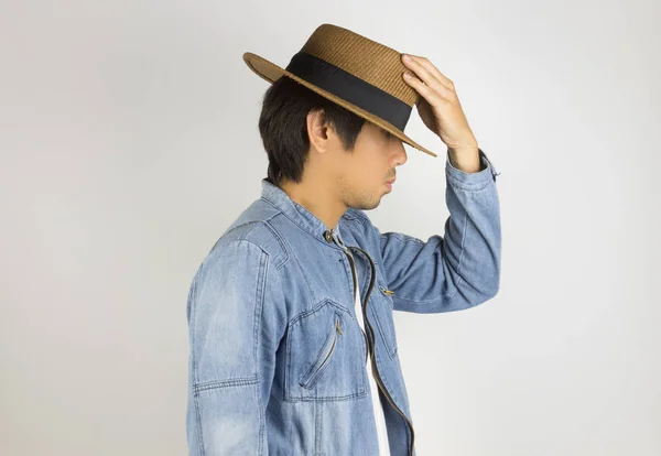 Young Asian Man in Jeans or Denim Jacket Touch Hat on Side View