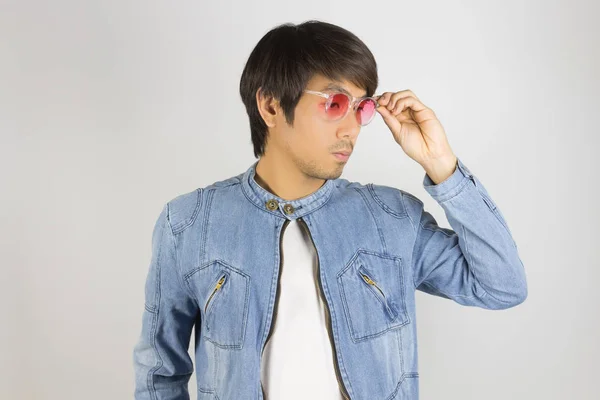 Young Asian Man in Jeans or Denim Jacket Wear and Touch Red Glas