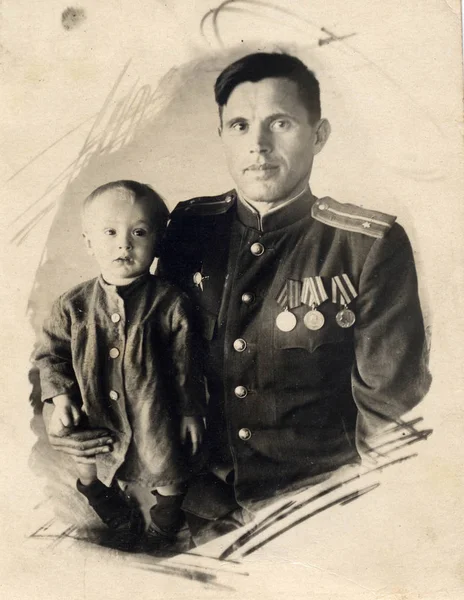 1940s, USSR, old photo of a man in uniform with his young son Royalty Free Stock Images