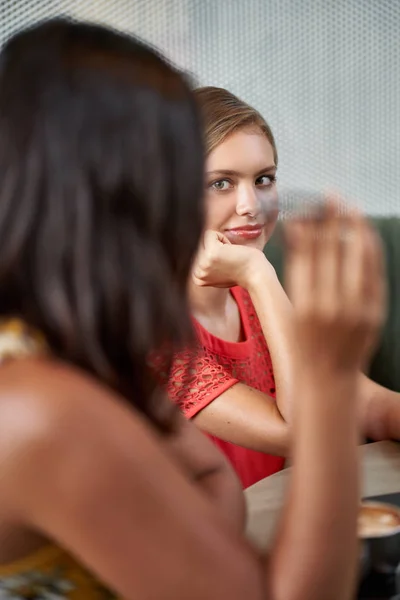 Unposed closeup lifestyle shot of young pretty mixed race businesswomen collaborating together wearing bright fashionable clothing — Stock Photo, Image