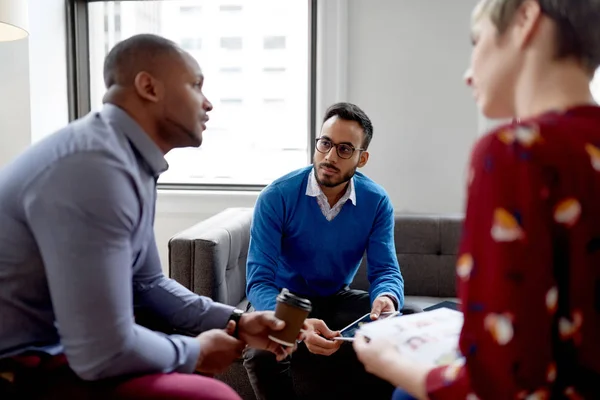 Multi-ethnic team of creative millenials collaborating on a brainstorm project