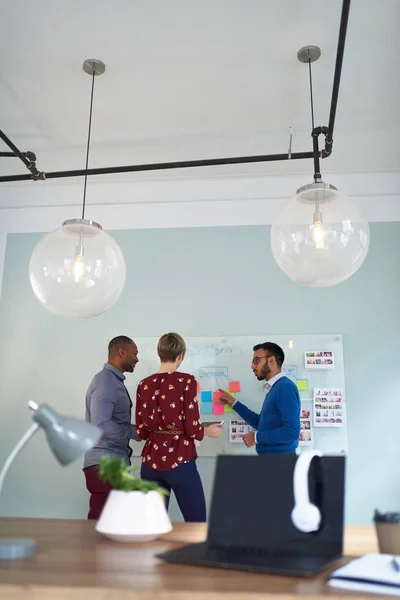 Diverse team of creative millennial coworkers in a startup brainstorming strategies in a modern office environment — Stock Photo, Image