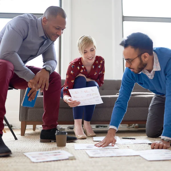 Multi-ethnic team of creative millenials collaborating on a brainstorm project