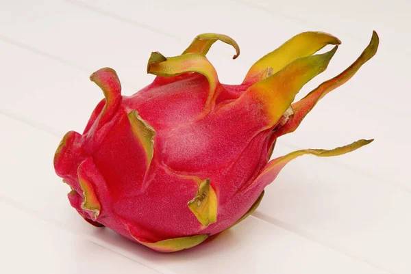red dragon fruit is on white background, pitahaya, dragon-fruit, pitaya on wooden table, isolated exotic fruit is as single object
