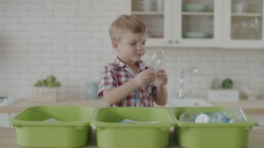 Anne ve oğlu geri dönüşüm için plastik ve cam atık ları ayıklama. Toddler plastik geri dönüşüm öğrenme. Çevre dostu aile çevre tasarrufu. 