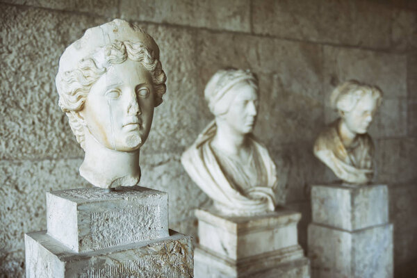 ATHENS, GREECE, SEPTEMBER 7, 2016: Statue heads from Museum of the Ancient Agora inside Stoa of Attalos, Athens, Greece.