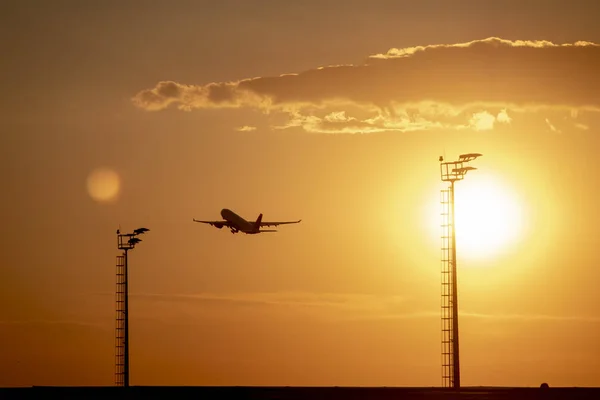 Airplane Taking Off From Airport At Sunset