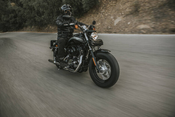Front view of classic motorbike rider riding an American classic motorcycle