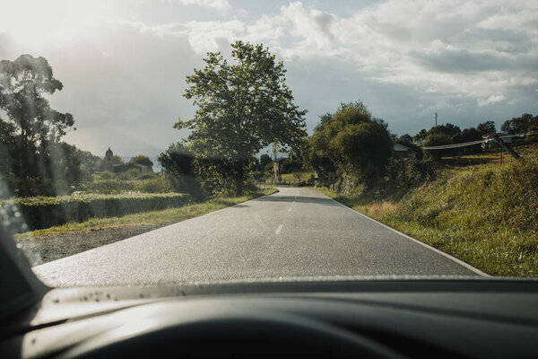 Slippery road, viewed from driver point of view while driving. Caution.