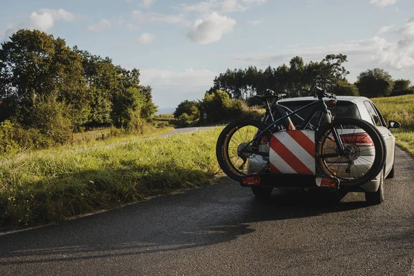 Mountain bikes on a car bike rack. Cycling vacations.