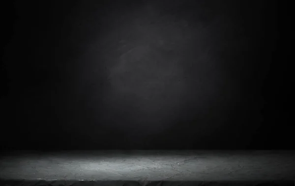 Dark room with tile floor and brick wall background.