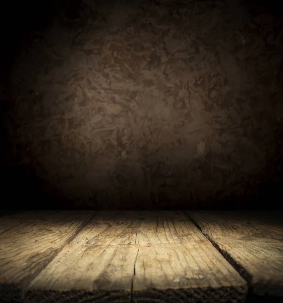 Dark room with tile floor and brick wall background.