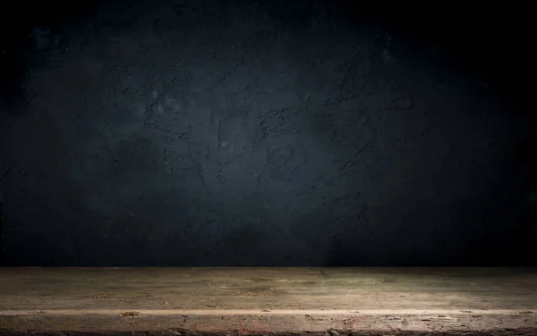 Old wood table with smoke in the dark background.