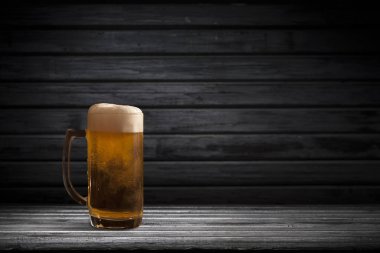 Koyu arkaplanda bir kupa bira