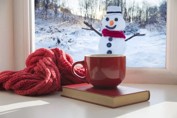 Чашка кофе на подоконнике. На заднем плане красивый зимний пейзаж в снегу. Уютная концепция дома — стоковое фото