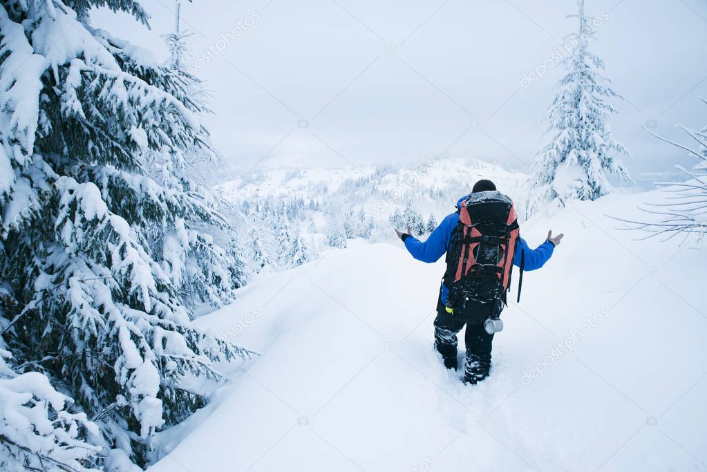 Mountain climber in bad weather during winter
