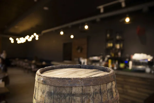 Beer barrel with beer glasses on a wooden table. The dark brown background.