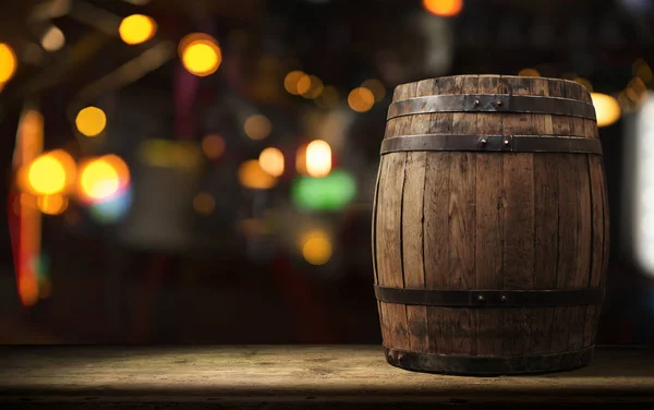 Oktoberfest beer barrel and beer glasses with wheat and hops on wooden table