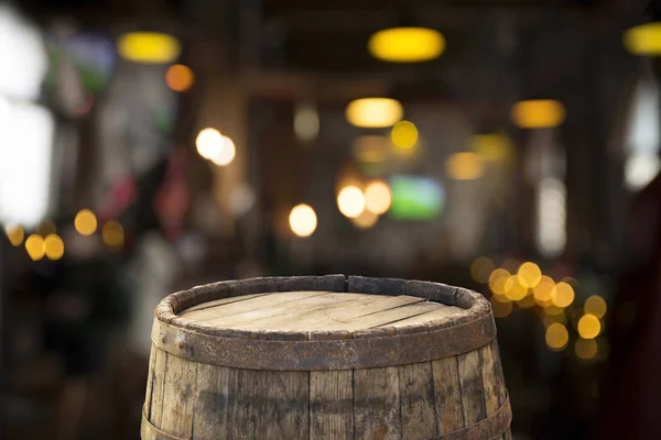 Beer barrel with beer glasses on a wooden table. The dark brown background.