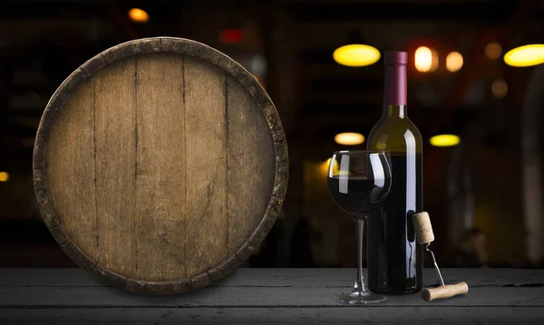 Expensive wine bottles collection and wooden barrel in the cellar, wine tasting and production concept