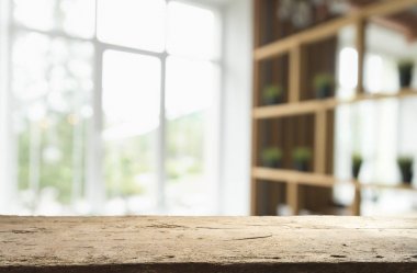 Pencere camından bulanık ahşap masa üstü ve bahçe manzaralı soyut yeşil sabah arka planda. Montaj ürünü görüntüsü için