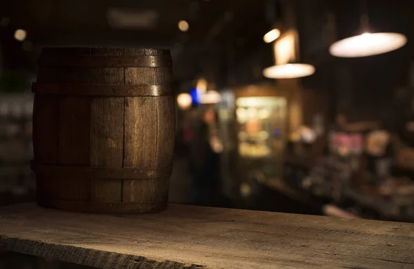 Beer barrel with beer glasses on a wooden table. The dark brown background.