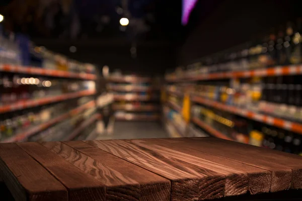 Wood top table on blur supermarket background