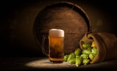 Bira şişesi, bardakta bira ve ahşap masa örtüleri. Metin için boş alan. Üst görünüm