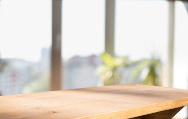 Perde arkaplan ile kapatılmış penceredeki ahşap masa