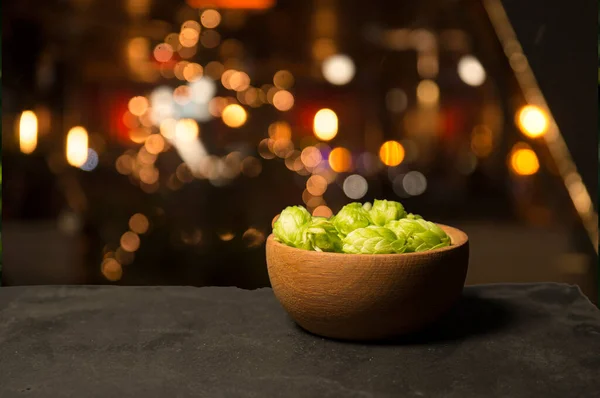 Beer brewing ingredients Hop in bag and wheat ears on wooden cracked old table. Beer brewery concept. Hop cones and wheat closeup. Sack of hops and sheaf of wheat on vintage background. — Stock Photo, Image