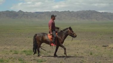 Ulaanbaatar Moğolistan, Mayıs, 5.2019: Moğolistan eteklerinde at süren bir Moğol binicisi.