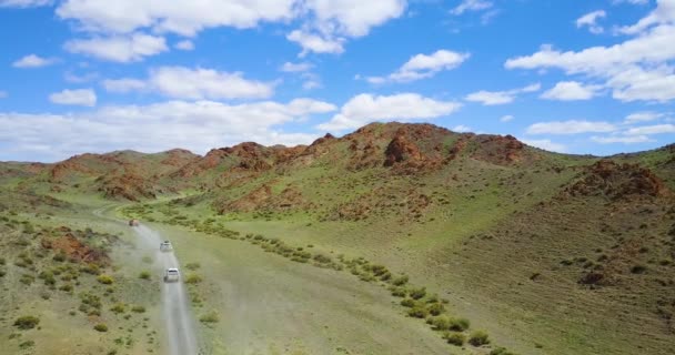 Bilar kör längs en bergsväg till en ravin i bergen i Mongoliet — Stockvideo