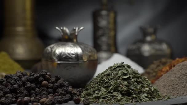 Orientaliska kryddor på en mörk bakgrund flytta på en brant yta — Stockvideo