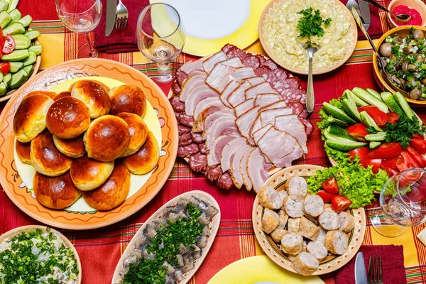 Cuts of meat and sausages on the holiday table .