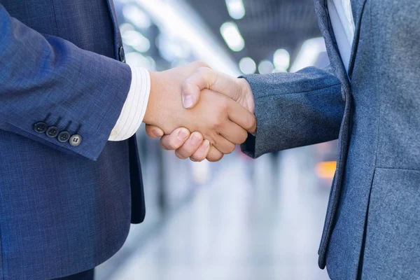 Businessmen handshaking after good deal. Business partnership meeting concept.