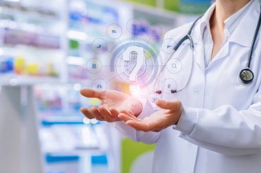 Pharmacist shows in the hands of a question mark . clipart