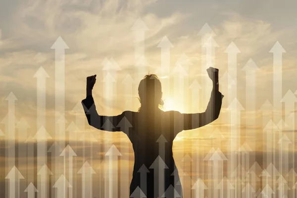 Concept of successful promotion and growth.Businesswoman with raised arms in the background of the arrows directed upwards.