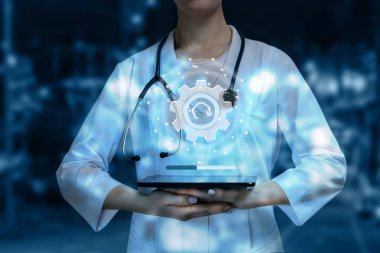 Bir doktor bir sağlık sistemi güncelleme dijital işaret sistemi ağ bağlantıları ve dişli cihazın yukarıda arka plan bulanık tutuyor. Tıbbi ağ sistem güncelleştirmesi kavramı.