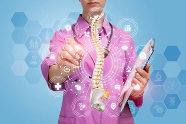 Yapay omurga modeli ile çalışan bir doktor.
