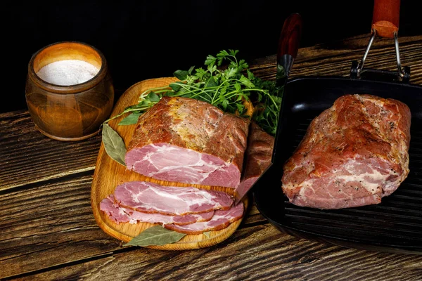 Ham sliced on a Board and a piece of meat in the pan — Stock Photo, Image