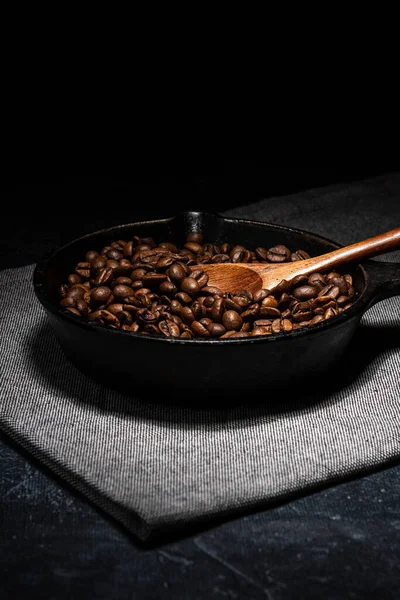 Grãos de café recém-torrados em uma frigideira de ferro fundido — Fotografia de Stock