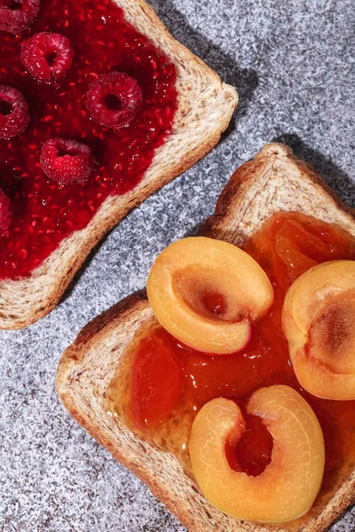 Toast with jam. Raspberry and apricot jam with berries. Fruit jam for Breakfast. Fresh and healthy Breakfast with toast