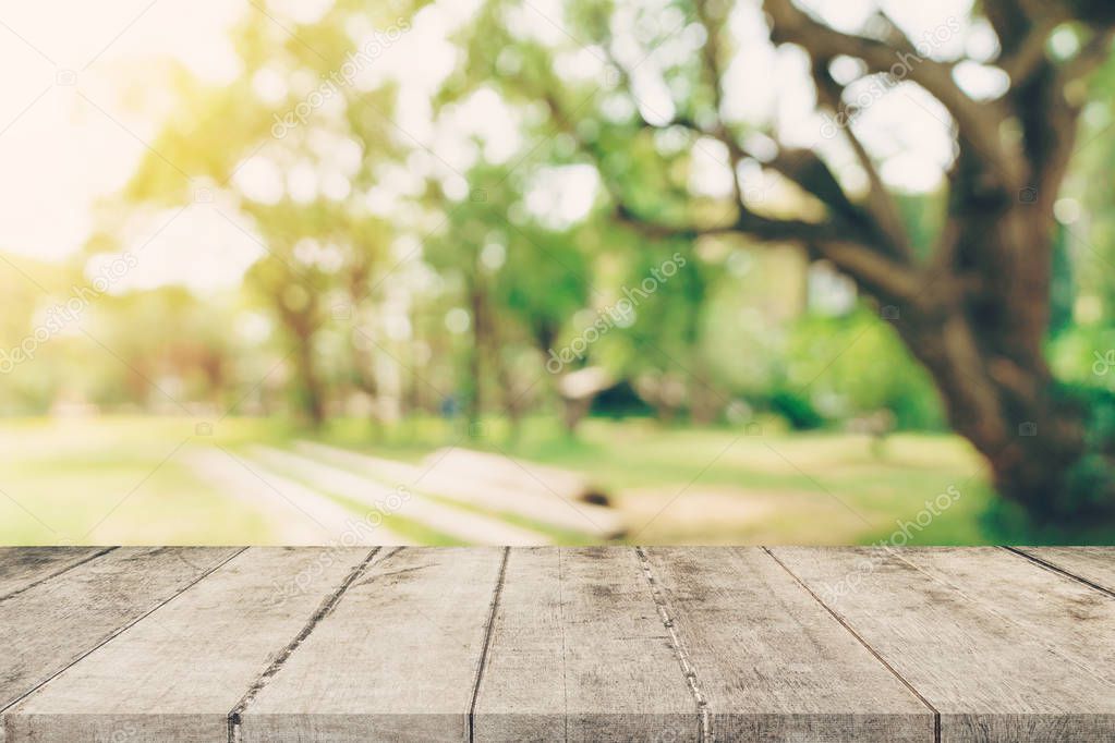 Empty wooden table top and green bokeh display montage for product with space.