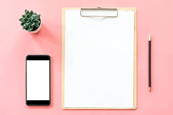 stationery, blank clipboard, smartphone, pot plant on pink paste